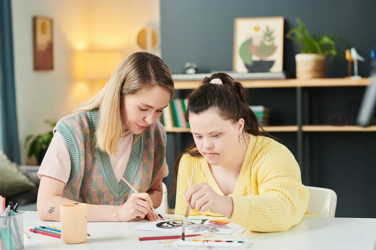 Two women taking part in a creative art activity together